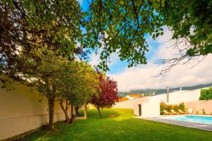 a house with a yard with a swimming pool at Afife Sea and Mountain Retreat in Afife