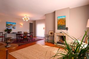 a living room with a fireplace and a dining room at Afife Sea and Mountain Retreat in Afife