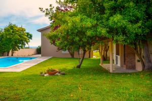 a yard with a swimming pool and a tree at Afife Sea and Mountain Retreat in Afife