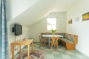 a living room with a table and a couch at Appartment Isabelle - Kamille in Lake Pressegg