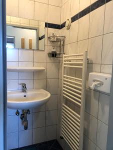 a white bathroom with a sink and a mirror at Appartment Isabelle - Kamille in Lake Pressegg