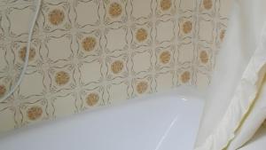 a bedroom with a wall with a patterned wallpaper at Ferienhaus Roman in Hinterstoder +17 photos