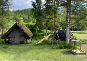 a play area with a tent and a slide at Ferienhaus Roman in Hinterstoder