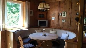 a dining room with a table and a window at Ferienhaus Roman in Hinterstoder