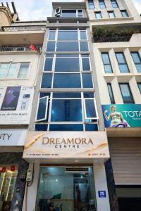 a facade of a building with a sign for dreamonia centre at Dreamora Centre Hotel in Hanoi