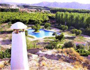 a lighthouse on a hill with a swimming pool at Los Cerezos in Benalúa de Guadix