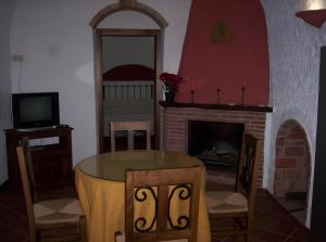 a dining room with a table and a fireplace at Los Cerezos in Benalúa de Guadix