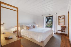 a white bedroom with a large bed and a window at Casa Do Alto Da Coutada in Ponte de Lima +22 photos