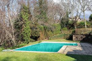 a swimming pool in the yard of a house at Casa Do Alto Da Coutada in Ponte de Lima