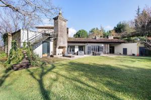 a house with a grass yard in front of it at Casa Do Alto Da Coutada in Ponte de Lima