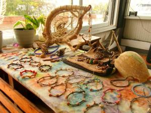 a table topped with a bunch of glasses and a basket at The Stoke Hideout Bagasbas Beach in Daet