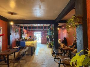 a restaurant with people sitting at tables in a room at The Stoke Hideout Bagasbas Beach in Daet +2 photos