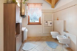 a bathroom with a white toilet and a sink at Casa Sergio in Grosio +23 photos