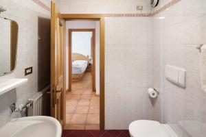 a bathroom with a sink and a toilet in a room at Ciasa Lino Rotic in Gardeccia - San Giovanni di Fassa +13 photos