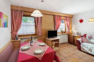a living room with a table and a couch at Ciasa Lino Rotic in Gardeccia - San Giovanni di Fassa