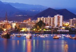 a harbor with boats in the water at night at Beach apartment in Los Cristianos in Los Cristianos