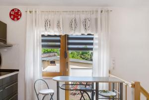 a table and chairs in a kitchen with a window at Ferienwohnung Gabi in Malchow