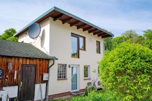 a house with a satellite dish on the side of it at Ferienwohnung Gabi in Malchow