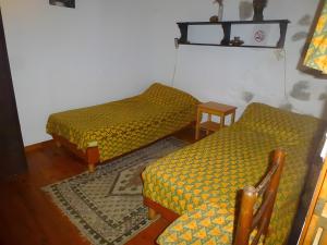 a room with two beds and a table at Gîte Paysan La Grange in Montrond