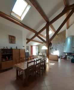 a large living room with a table and chairs at Gîte Paysan La Grange in Montrond