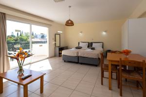 a bedroom with a bed and a dining room at Mariela Hotel Apartments in Polis Chrysochous +52 photos