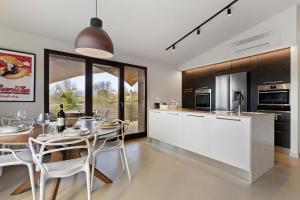 a kitchen and dining room with a table and chairs at Isola Degli Angeli in Reggello +28 photos