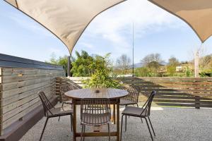 a table and chairs sitting under an umbrella on a patio at Isola Degli Angeli in Reggello