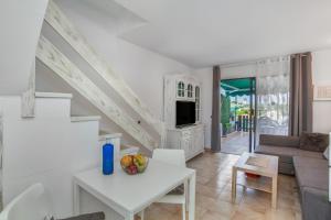 a living room with a couch and a table at Great Bungalow Maspalomas in Maspalomas