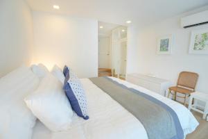 a bedroom with a large bed with white pillows at P8 Cliff House Stunning Seaview in Ban Ko Kok +21 photos