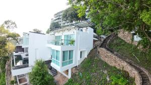 a white house on top of a hill at P8 Cliff House Stunning Seaview in Ban Ko Kok