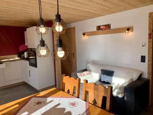 a room with a table and a kitchen with a dining room at L'échappée Belle - Chatel in Châtel