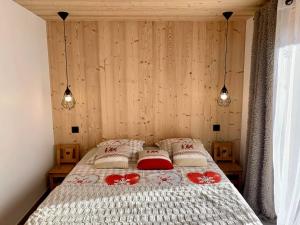a bedroom with a bed with two pillows on it at L'échappée Belle - Chatel in Châtel