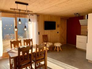 a kitchen and dining room with a table and chairs at L'échappée Belle - Chatel in Châtel +20 photos