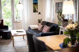 a living room with a couch and a table at Ferienwohnung Auf Dem Schönen Felde in Brilon