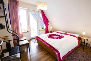 a bedroom with a bed and a large window at Ferienwohnung Auf Dem Schönen Felde in Brilon +16 photos