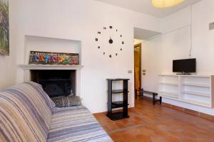 a living room with a couch and a fireplace at Villa G By Immobilux in Nago-Torbole
