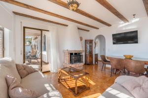 a living room with a couch and a fireplace at Casa Romantica in Salobreña