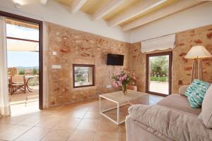 a living room with a couch and a table at Son Rossinyol Nou - Sa Bovera in Islas Baleares