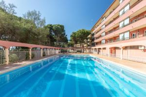 a swimming pool in front of a building at Salines in L'Estartit