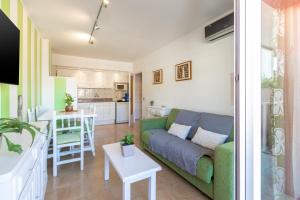 a living room and kitchen with a couch and a table at Salines in L'Estartit