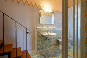 a bathroom with a sink and a toilet at Palazzo Cofani in Arezzo +30 photos