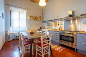 a kitchen with a wooden table and a dining room at Palazzo Cofani in Arezzo