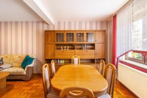 a dining room with a wooden table and a couch at Zum weißen Roß in Hausen +20 photos