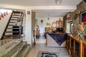 a living room with a staircase and a couch at Casa Real De Cima in Fervença