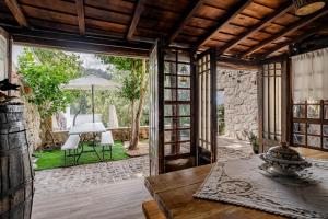 an open living room with a table and a patio at Casa Real De Cima in Fervença