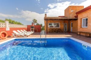a swimming pool in front of a house at Villa Atlantic Ocean Private Pool in Corralejo