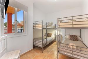 two bunk beds in a room with a window at Villa Atlantic Ocean Private Pool in Corralejo +24 photos