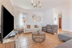 a living room with a large tv and a couch at Villa Atlantic Ocean Private Pool in Corralejo