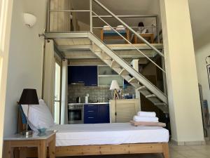 a room with a bunk bed and a staircase at Aoni Suites in Egina