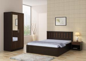 a bedroom with a bed and a cabinet in it at City Palace in Zirakpur